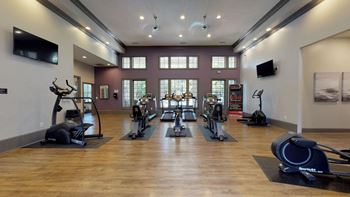 A gym with treadmills and other exercise equipment
